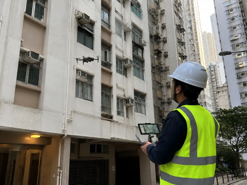 Drone capturing high-resolution imagery of a Hong Kong building façade